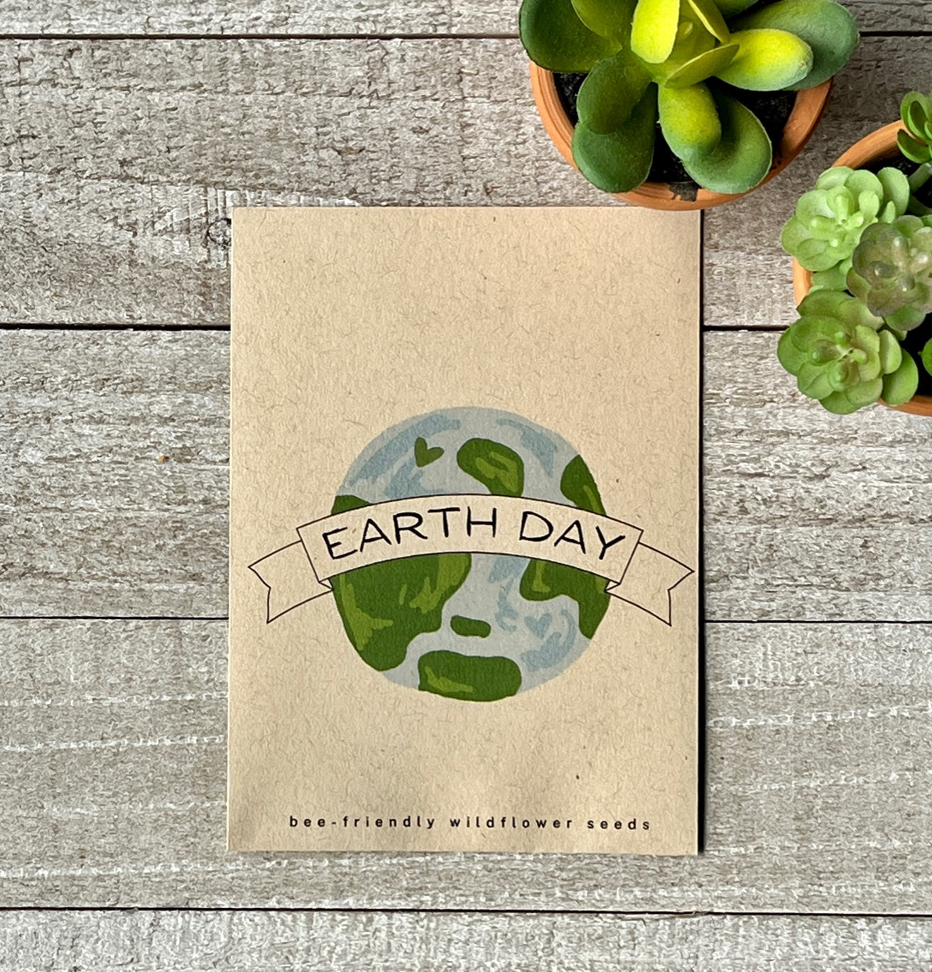 A brown seed packet with an illustration of the earth and the words, Earth Day.