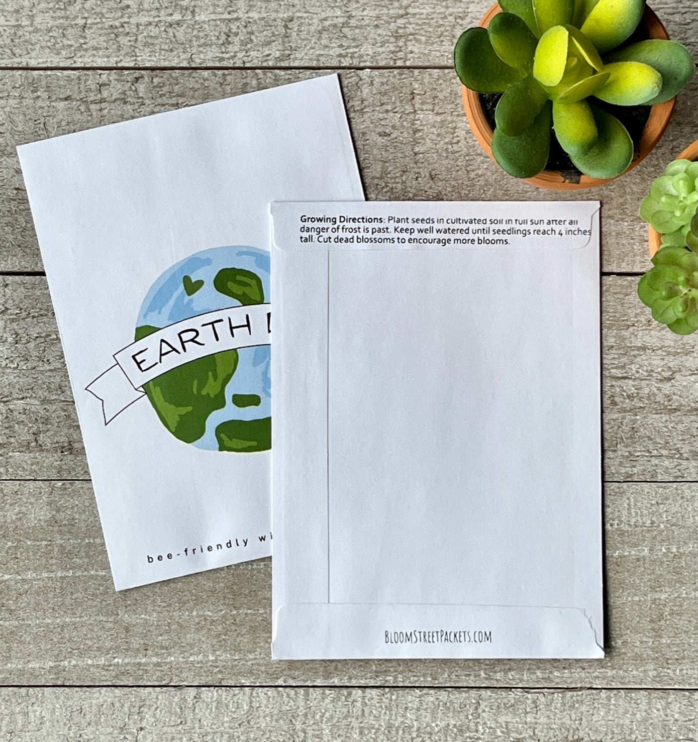 A front and back view of a white seed packet, the back view showing planting instructions.