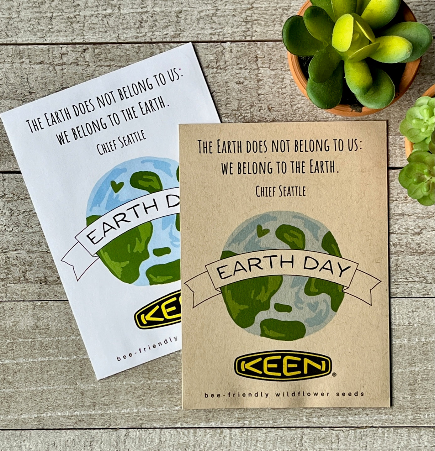 A white and a brown seed packet with an illustration of the earth and a company logo and text.