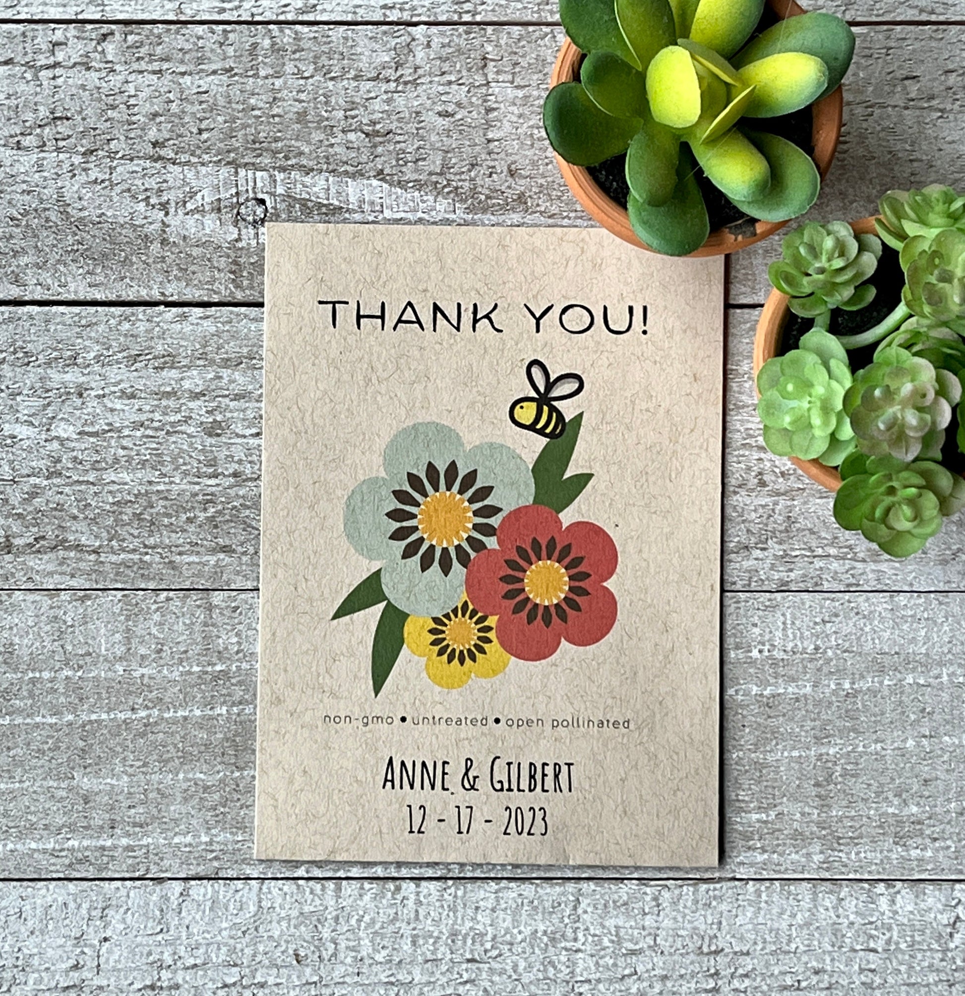 A brown seed packet with blue, yellow and red flowers and the words Thank You.