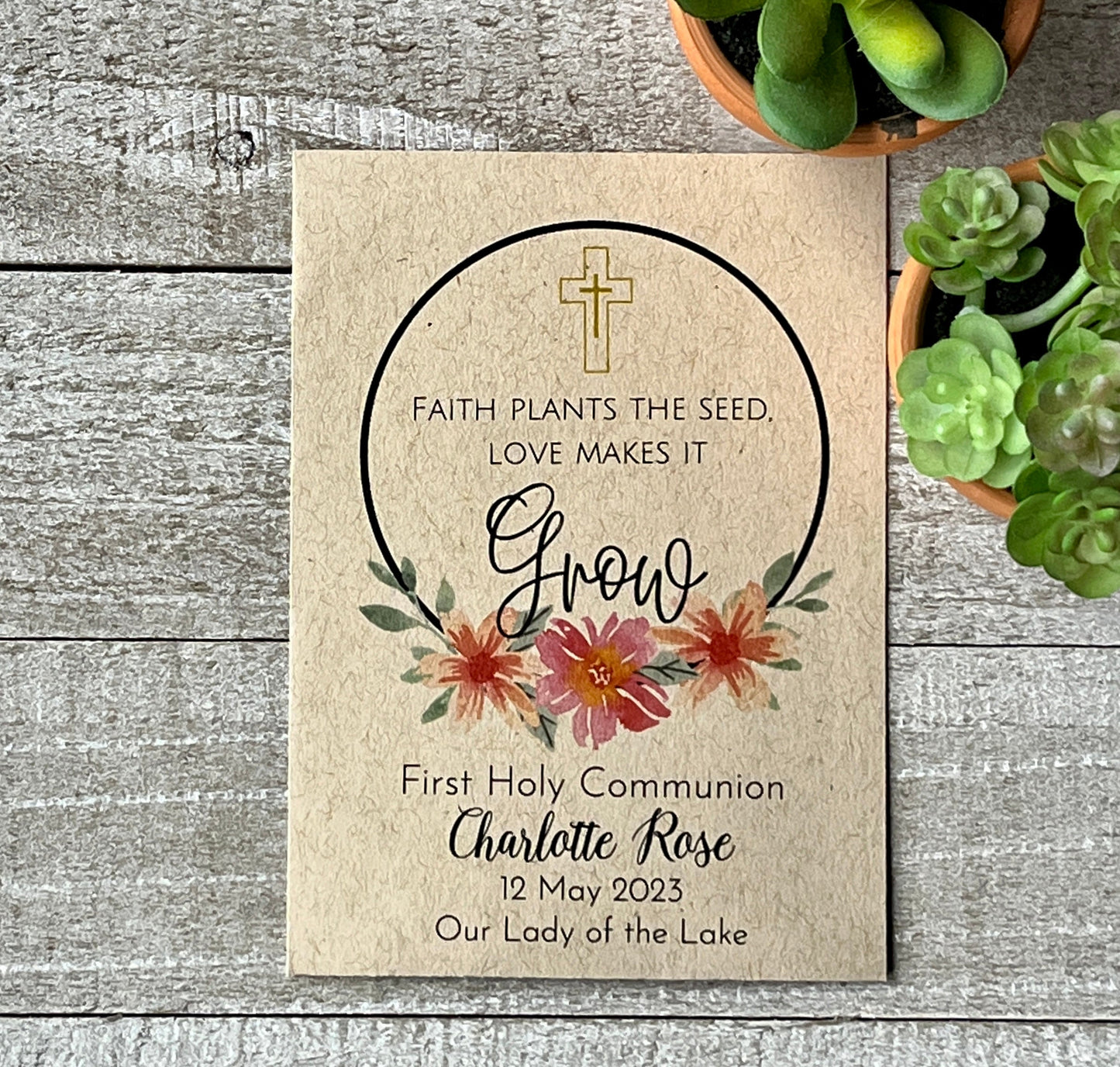 A brown seed packet with pink flowers a cross and a spiritual message about faith.