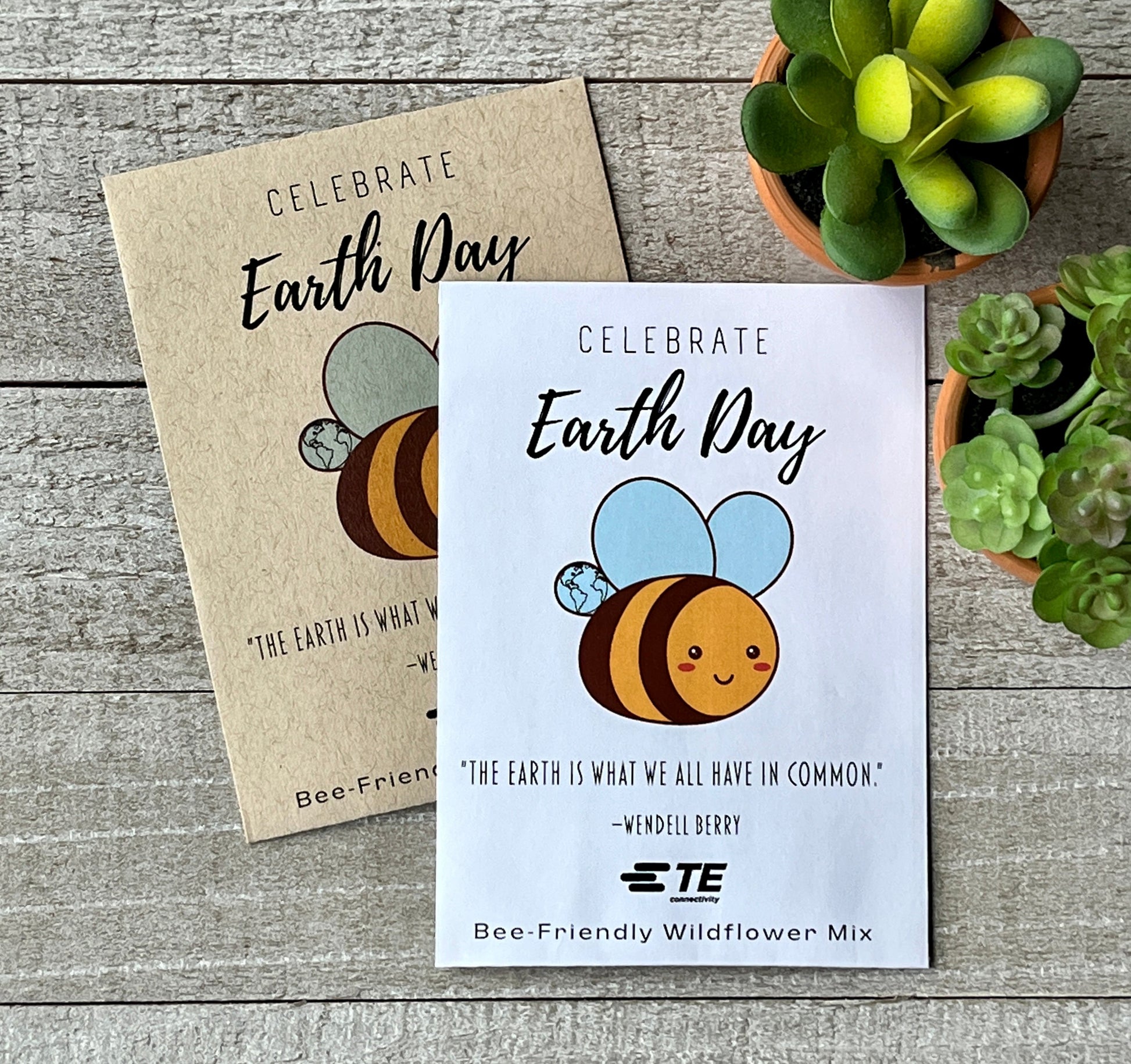 A white and a brown seed packet with a large, cartoon bee and the words, Happy Earth Day.