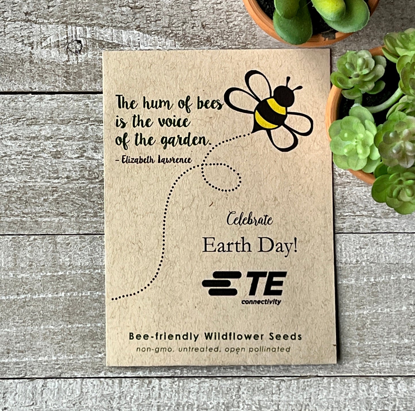 A brown seed packet with a drawing of a buzzing bee and a quote about bees.