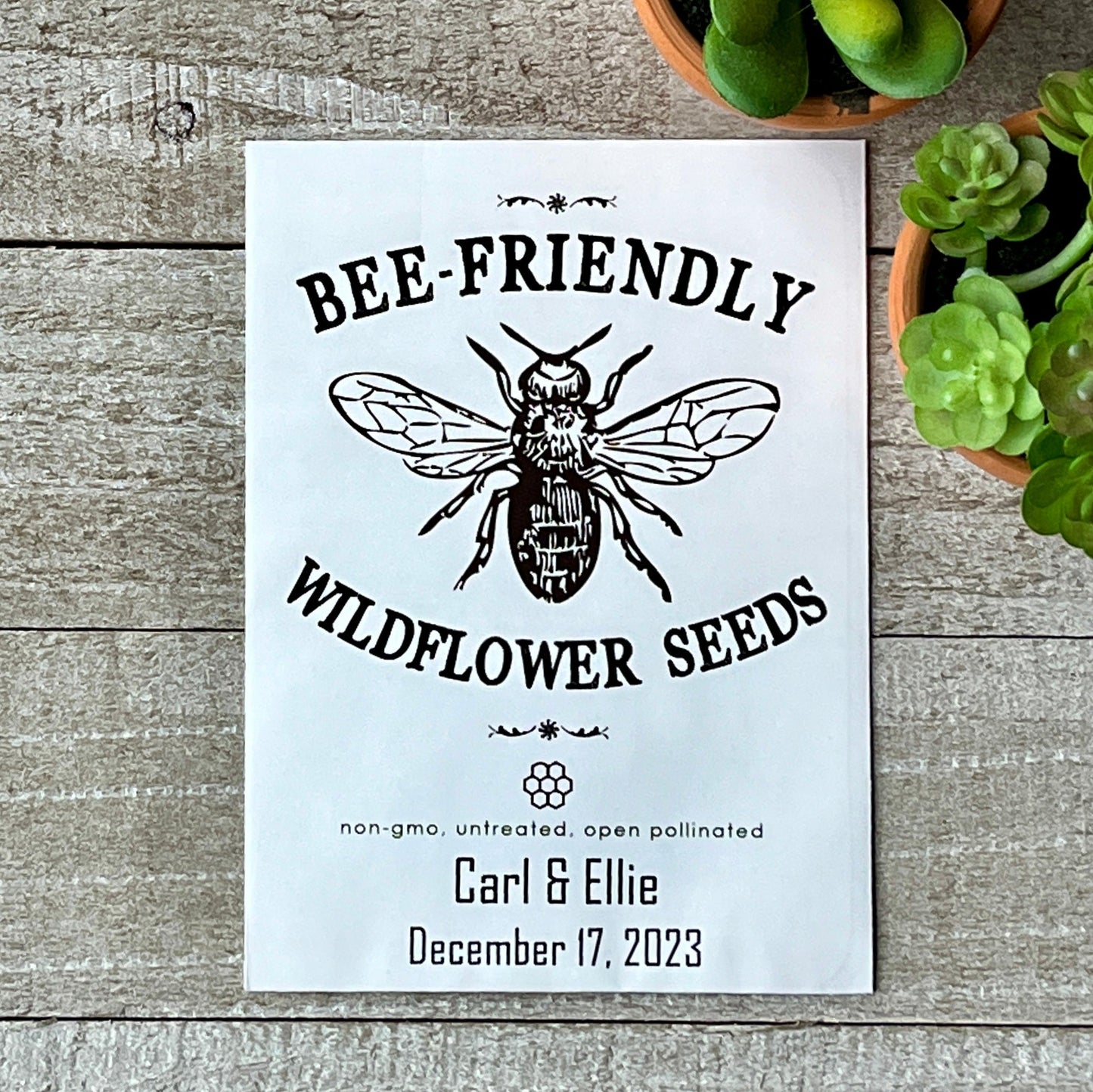 A white seed packet that has a large line drawing of a bee and the words "bee-Friendly."