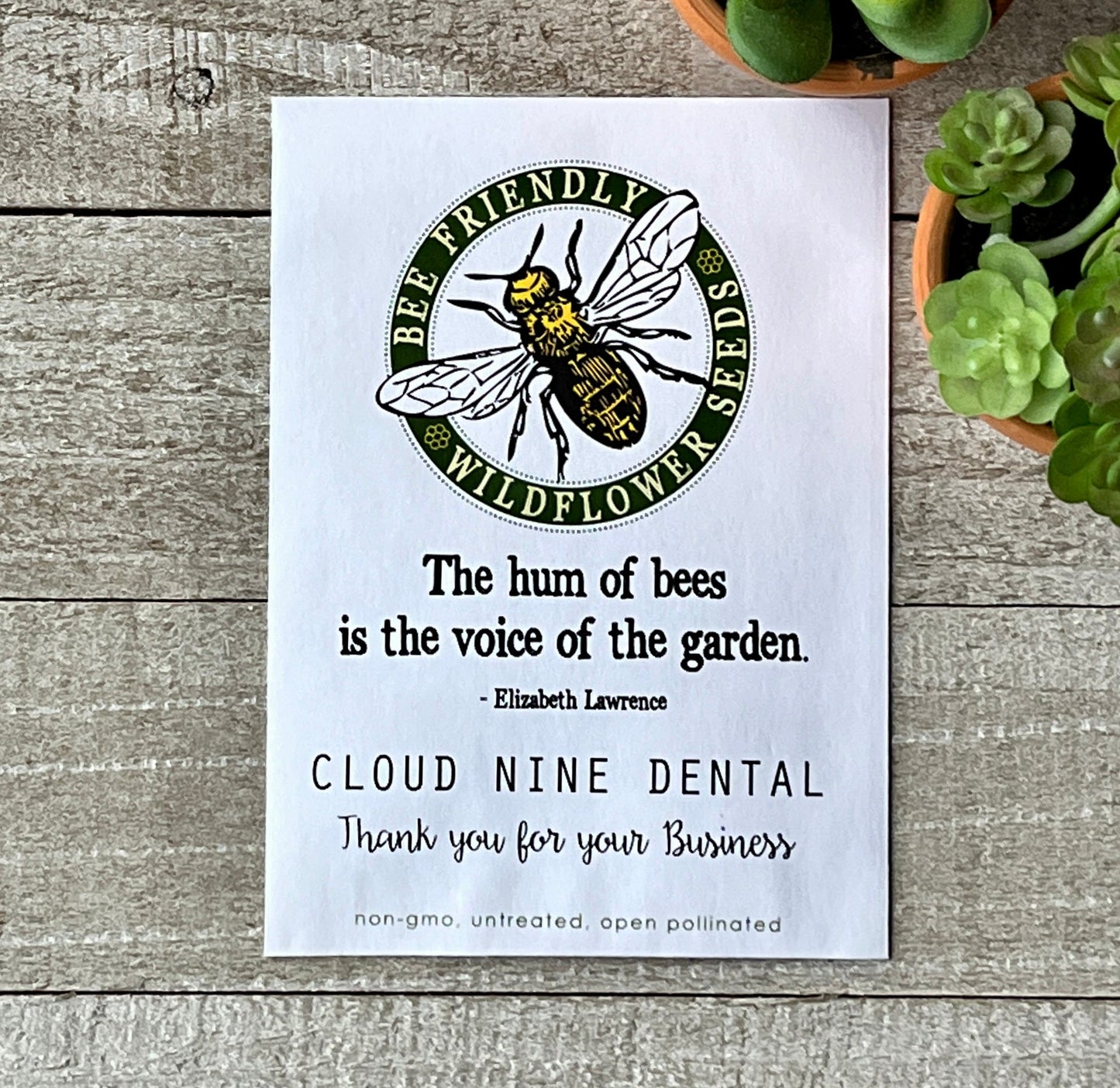 One white seed packet with a honey bee in a circle and a quote about bees.